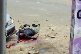 PHOTOS: Police Abandon Their Vehicle As Shiite Protesters Stone Policeman To Death