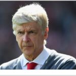 Ex Arsenal manager, Arsene Wenger with grey hair and red tie