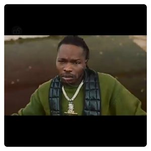 Naira Marley in green top in video of As E Dey Go