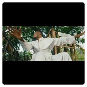 Qdot Alagbe in white garment on the music video for "Jegele"