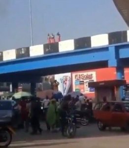 3 Young Men On Red Wrapper Caught Taking Their Bath On A Bridge In Ibadan (Video)