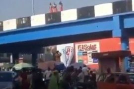 3 Young Men On Red Wrapper Caught Taking Their Bath On A Bridge In Ibadan (Video)
