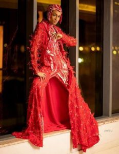 Denrele Edun on red dress at his birthday party