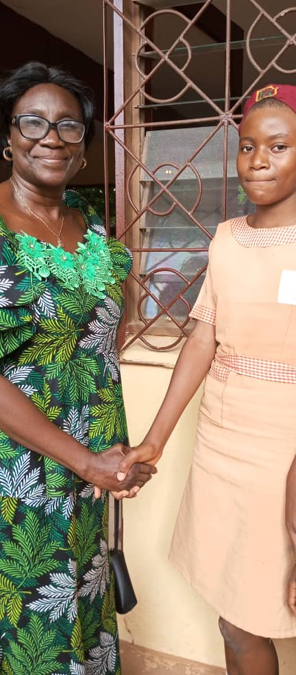 Receiving presidential hand shake from the Principal of the school.